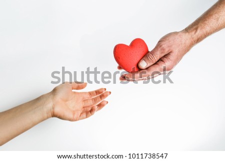 heart transferred from hand to hand, love and care through the heart, a symbol of support. hope and love