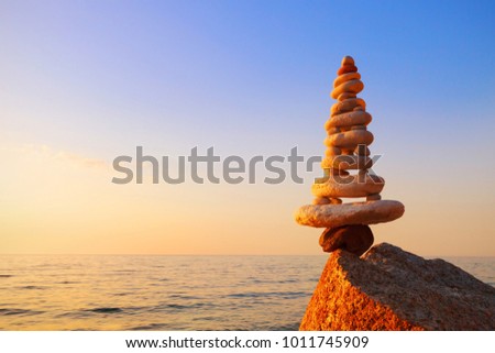 Stones balance on a background of sea sunset. Calm and meditation. Concept of harmony and balance. copy space