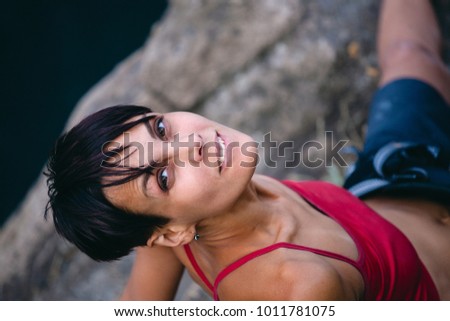 portrait of a girl in nature. Girl in a red shirt and tanned skin.