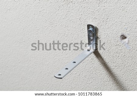 The bracket is fixed to the wall foam or aerated concrete with a screw