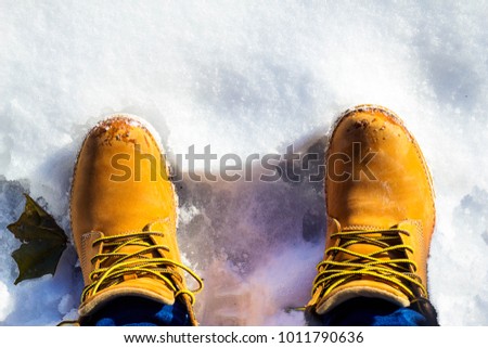 Timberland boots in the snow Royalty-Free Stock Photo #1011790636