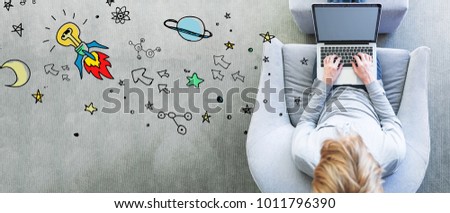 Idea Rocket with man using a laptop in a modern gray chair