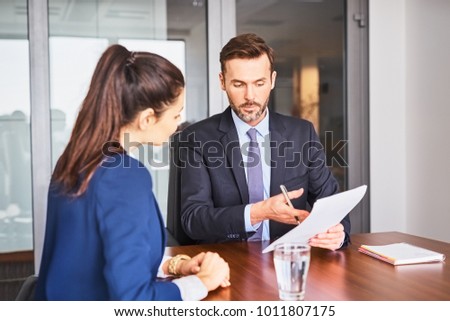 Recruiter conducting business job interview with female applicant in office Royalty-Free Stock Photo #1011807175