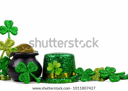 St Patricks Day Pot of Gold, shamrocks and leprechaun hat. Corner border over a white background.