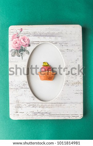 Dessert - cake tarts with fruits and berries in the picture frame on a green background. Fresh delicious food.