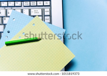 pencil, yellow, blue Notepad sheets for recording and laptop. Office theme.