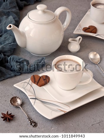 Two cups of coffee and heart shaped cookies on vintage background. Close-up, selective focus, shallow depth of field. A concept for Valentine's day, engagement and other romantic events