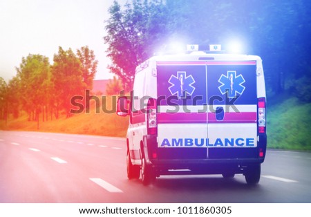 Ambulance van on highway with flashing lights Royalty-Free Stock Photo #1011860305
