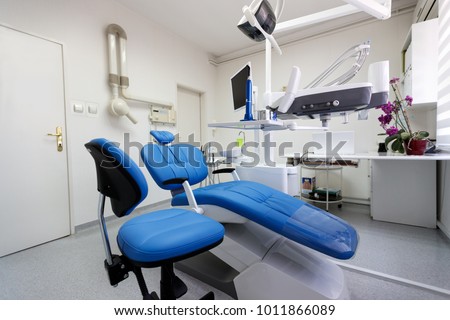 Dental ordination with blue dental chair and apparatus Royalty-Free Stock Photo #1011866089