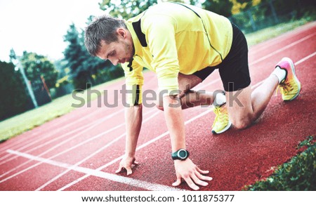 Runner in starting position. Sport, fitness, athletics concept