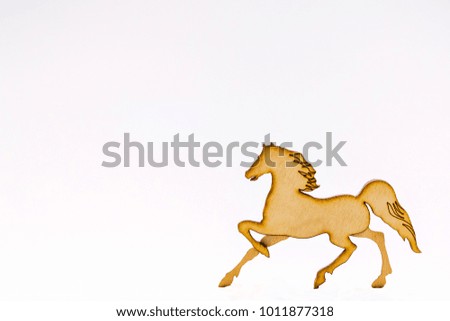 Horse, carved from wood, with developed mane and tail, on white background, Wooden horse decor, cooked from solid wood. Winter, Christmas, New Year, events, wooden pine finish. Isolated on white