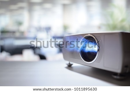 LCD video projector at business conference or lecture in office with copy space Royalty-Free Stock Photo #1011895630