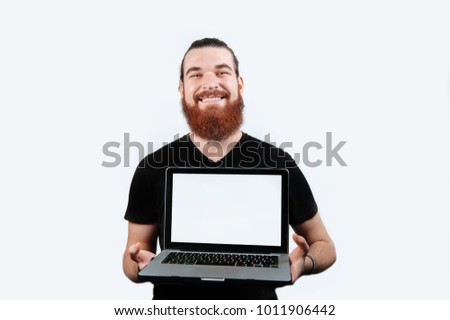 Bearded hipster smiling man with laptop computer on a white background