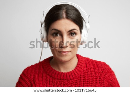 Young and pretty woman listening to the music with closed eyes