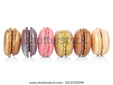 French luxury colorful macarons dessert cakes on white background with sugar on top