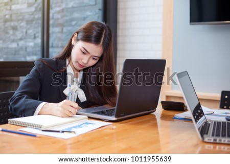 Business woman asian who use a computer laptop at work in the office.