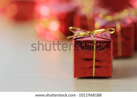 Focus in red gift box place on wooden floor and background of unsharp in the concept of festive design important.