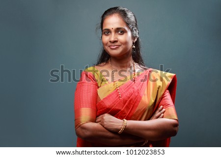 Portrait of a traditionally dressed woman of Indian origin Royalty-Free Stock Photo #1012023853