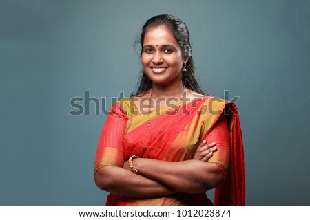 Portrait of a traditionally dressed woman of Indian origin Royalty-Free Stock Photo #1012023874