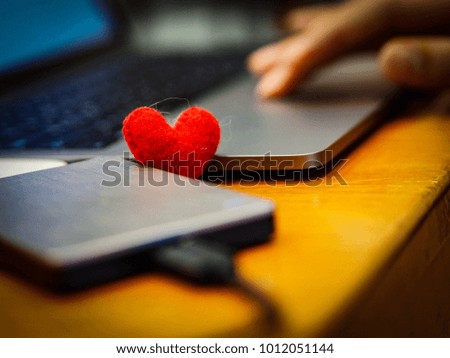 Close Up man hand Keyboard typing at for work, Red heart love background.