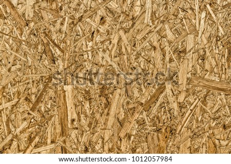 The texture of the surface of the OSB panel as a background.