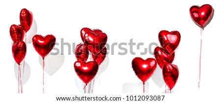 Set of Air Balloons. Bunch of red color heart shaped foil balloons isolated on white background. Love. Holiday celebration. Valentine's Day party decoration. Metallic red colour Heart air ballons Royalty-Free Stock Photo #1012093087