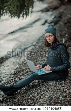 girl with a computer in nature
