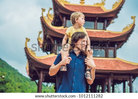 Happy tourists dad and son in Pagoda. Travel to Asia concept. Traveling with a baby concept.