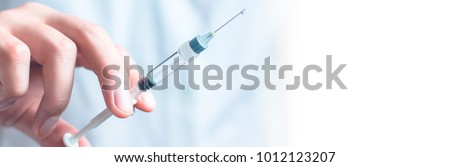 Syringe, medical injection in hand, palm or fingers. Medicine plastic vaccination equipment with needle. Nurse or doctor. Liquid drug or narcotic. Health care in hospital. Royalty-Free Stock Photo #1012123207