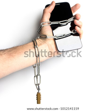 iron chain with lock ties together hand and smart phone. mobile phone addiction concept. isolated