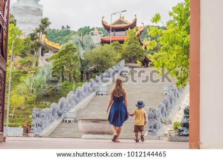 Happy tourists mom and son in Pagoda. Travel to Asia concept. Traveling with a baby concept.