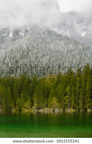 Snowy day at lake Hintersee in the Alps of Bavaria on a day in early spring