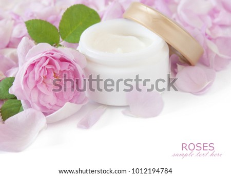 Rose petals and cosmetic cream isolated on white background