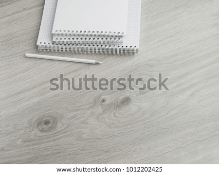 Empty notebooks and a pencil on a wooden gray table. Back to school. Top view. Copy space.
