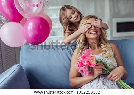 I love my mom! Attractive young woman with little cute girl are spending time together at home. Happy family concept. Mother's day.