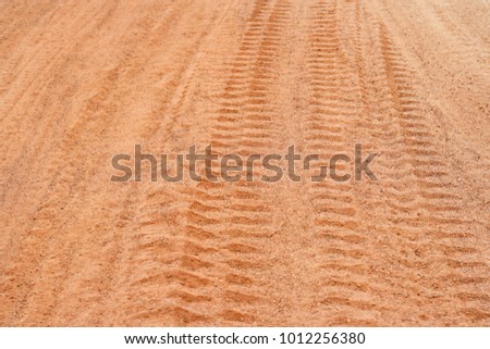 Tractor tire tracks on dirt road