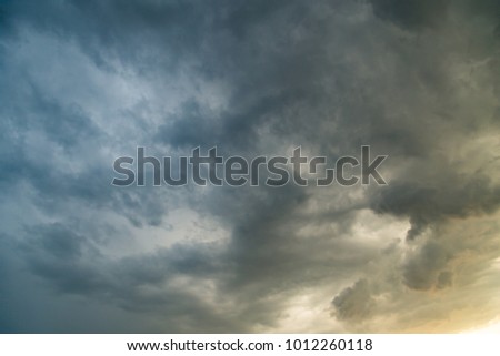 Storm clouds in the sky at sunset as background