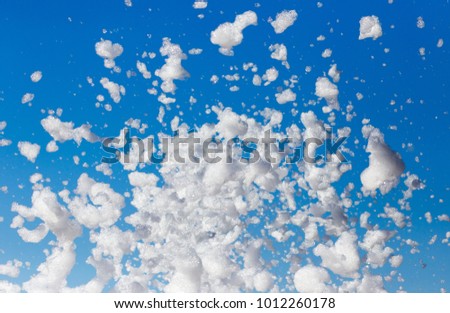 White foam against the blue sky as background