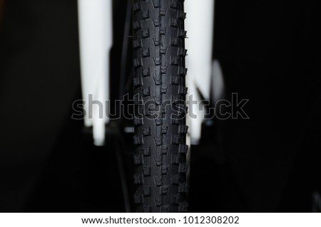 bicycle tyre on black background