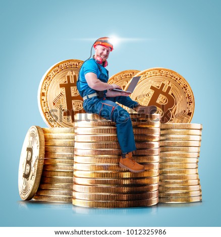 Miner man posing with a golden bitcoin stacks of coins on a background. Virtual cryptocurrency concept. Bitcoin mining.
