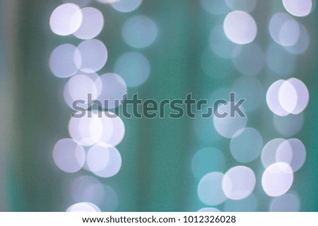 Abstract bokeh on soft blue background.