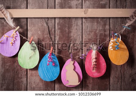 Easter paper eggs on wooden background