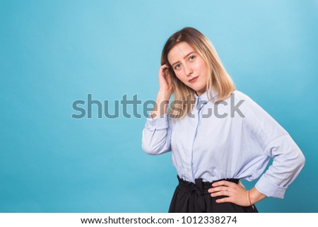 Portrait of young beautiful cute cheerful girl smiling looking at camera over blue background.