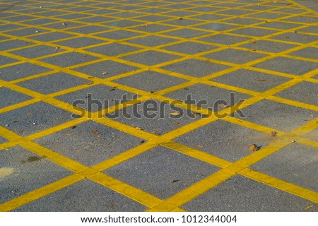 ‘Don’t park here !’ - yellow diagonal lines on asphalt road