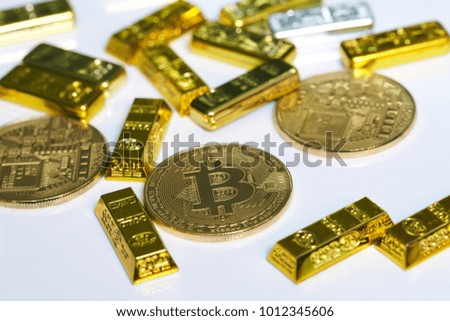 Golden bitcoin coin and Gold bars on the white background.