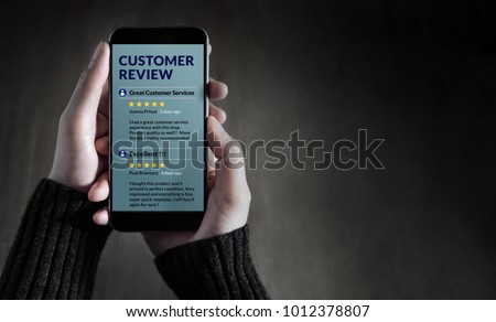Customer Experience and Online Review Concept. Female holding SmartPhone to Reading Customer Review before Buying Products Royalty-Free Stock Photo #1012378807