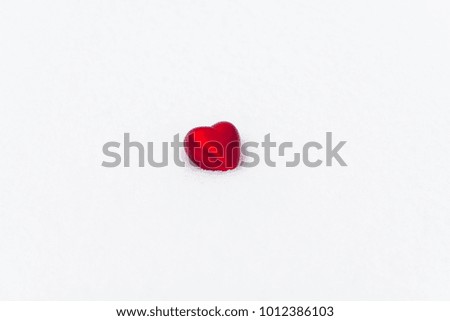 red heart on white background/snow