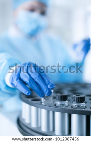 Young female scientist working in laboratory Royalty-Free Stock Photo #1012387456