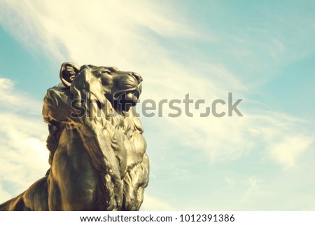 Detail of statue of a king lion, which belongs to Christopher Columbus monument. It is located in Plaza del Portal de la Pau in Barcelona, Spain. Columbus discovered America in 1492.