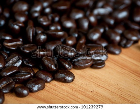 Roasted coffee  beans  on wood texture.